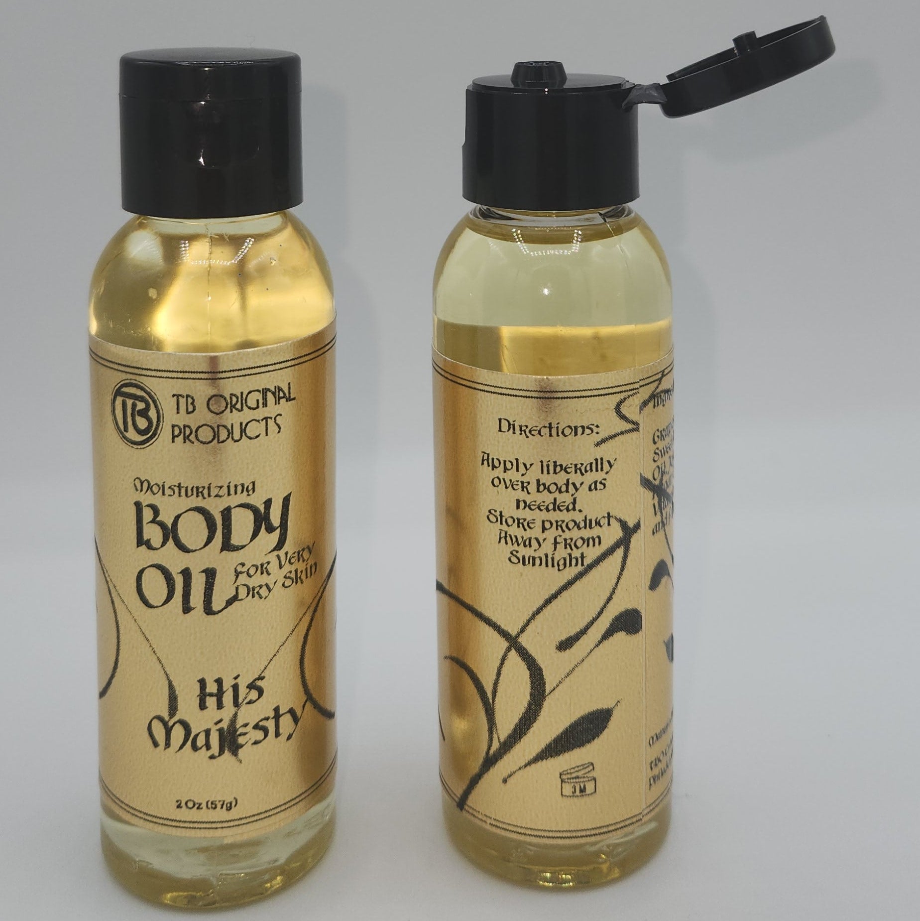 Two bottles of body oil with visible labels on a light gray background