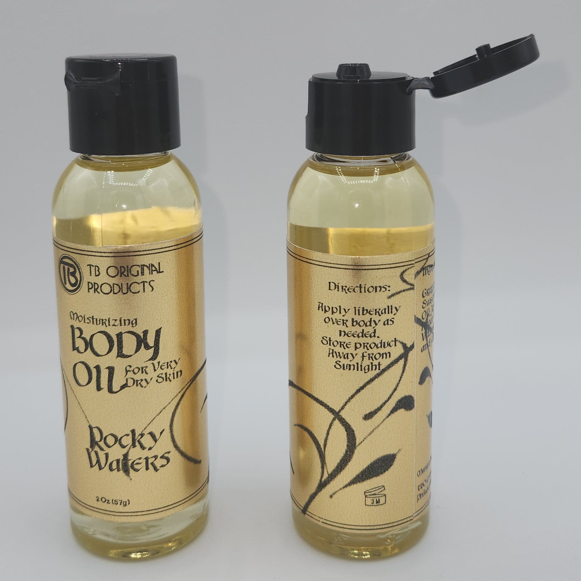 Two bottles of moisturizing body oil on a white background