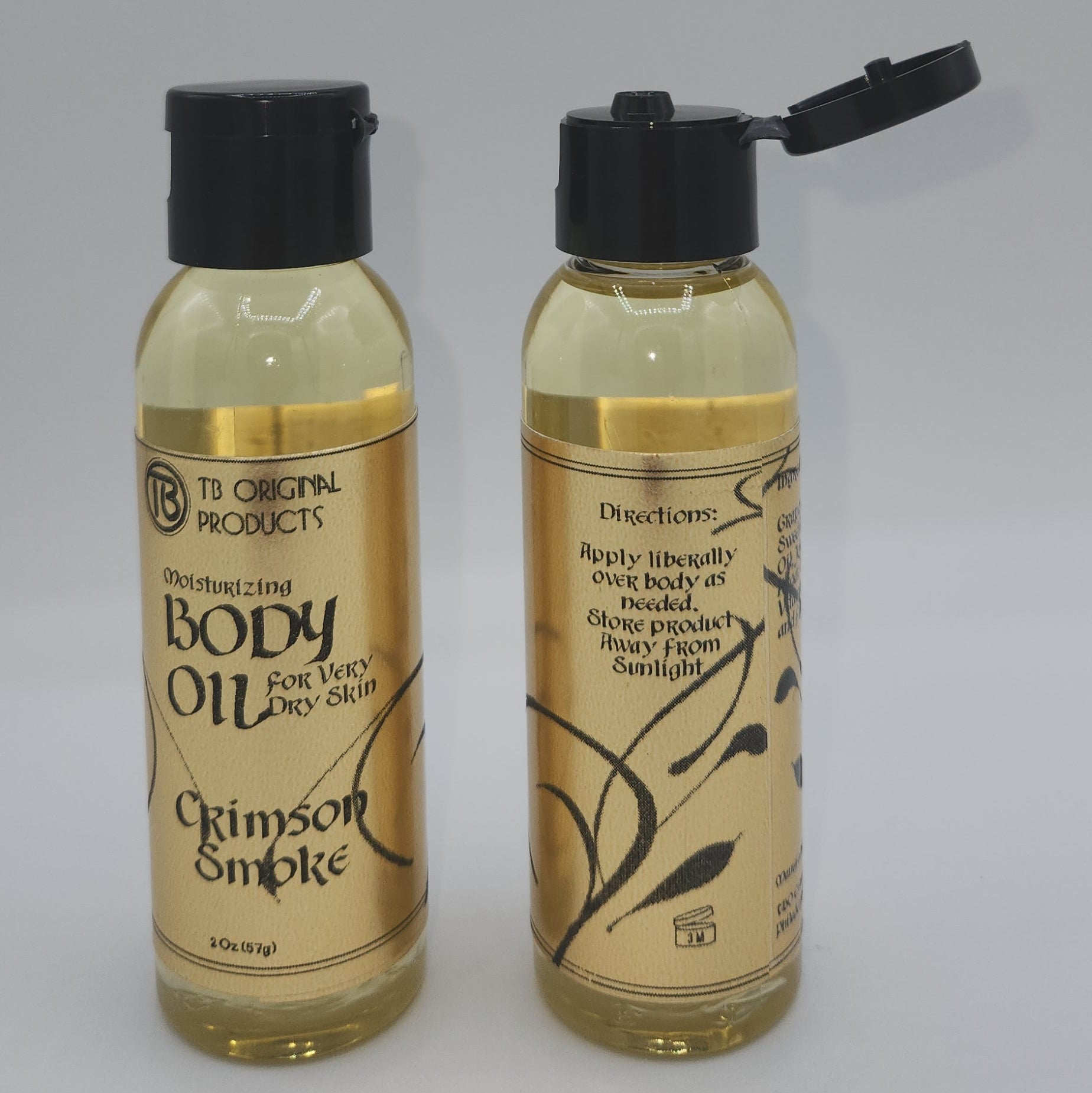 Two bottles of body oil on a white background
