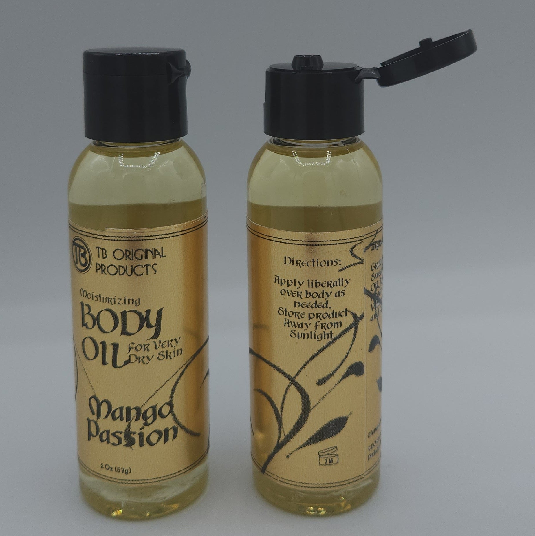 Two bottles of 'Mango Passion' oil with black caps on a gray background